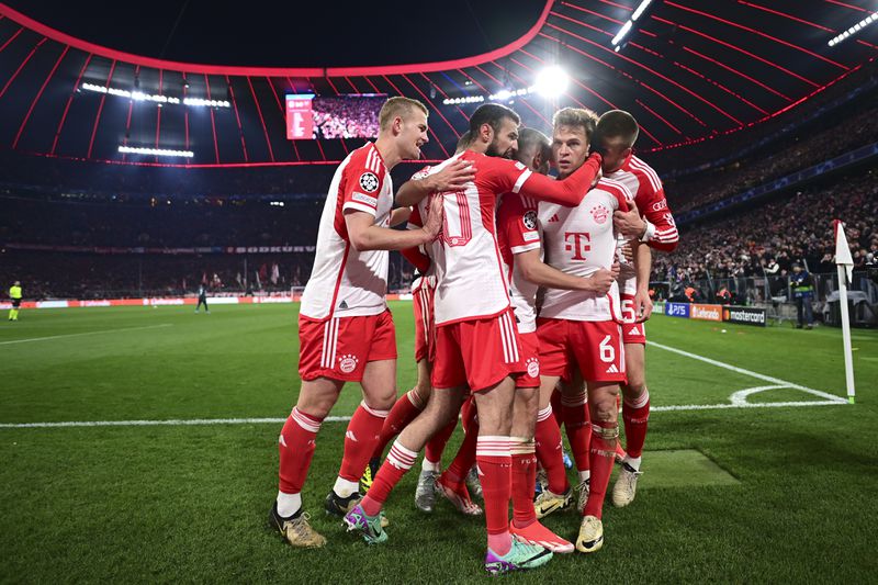 Bayern's Joshua Kimmich, centre right, celebrates with teammates after scoring his side's opening goal during the Champions League quarter final second leg soccer match between Bayern Munich and Arsenal at the Allianz Arena in Munich, Germany, Wednesday, April 17, 2024. (AP Photo/Christian Bruna)