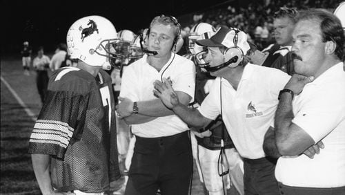 Former Brookwood High School football coach Dave Hunter (center right in headset). AJC file photo