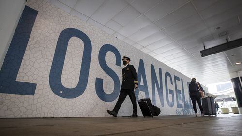 Travelers at Los Angeles International Airport. On Friday, a passenger opened the door of a plane as it was taxiing away from the gate area and jumped out.