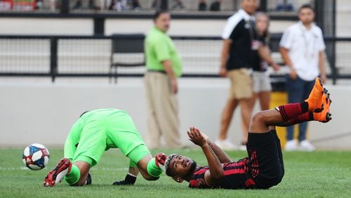 June 10, 2019 Kennesaw- Josef Martinez, 7, forward for Atlanta United, collides with the Saint Louis FC goalkeeper, Tomas Gomez, during the first half of a match between Atlanta United and Saint Louis FC at Kennesaw State University in Kennesaw, Georgia on Wednesday, July 10, 2019. Atlanta United and Saint Louis FC were tied 0-0 at the end of the first half. Christina Matacotta/Christina.Matacotta@ajc.com