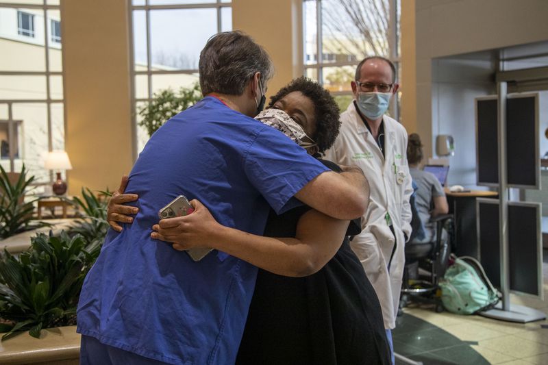 Radiologist Matthew McClain embraces Josetta Cooke at Floyd Medical Center in Rome earlier this week. McClain helped to diagnose Cooke one year ago. (Alyssa Pointer / Alyssa.Pointer@ajc.com)