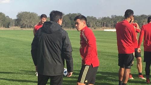 Atlanta United's Ezequiel Barco talks with an assistant coach on Wednesday during training camp in Florida.