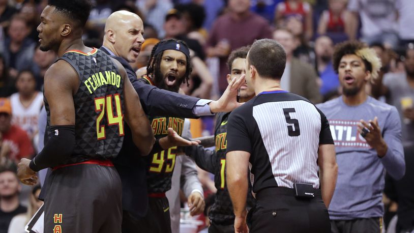 Referee Kane Fitzgerald ejects Hawks guard DeAndre' Bembry (middle) during the second half. (AP Photo/Matt York)