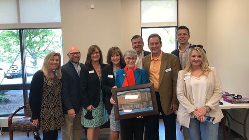 From left: Julie Haley, Bruce Gunning, Holly York, Mary Good, Barbara Duffy, John Carpentier, Bill Brower, Bryan Apinis and Heather Jallad at the opening of the North Fulton Community Charities Duffy Center. (Courtesy North Fulton Community Charities)