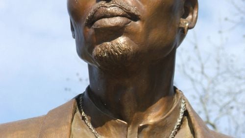 In this file photo, a life-size bronze statue of Tupac Shakur presides over the "Peace Garden" at the Tupac Amaru Shakur Center for the Arts in Stone Mountain. The statue left after the center closed.
