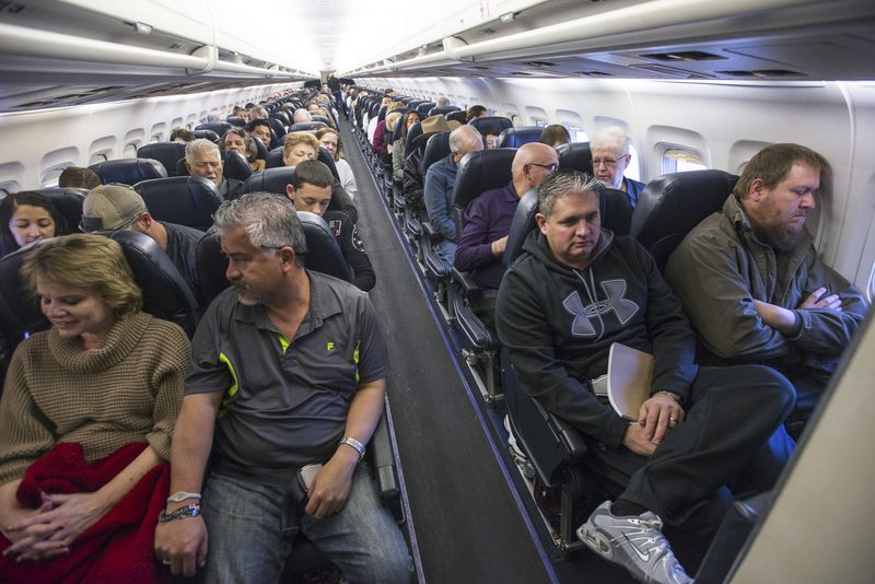 Passengers on a flight in Las Vegas. (Joe Giron/The New York Times)