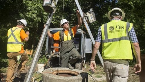 Contractors for Compliance Envirosystems do work on DeKalb County's sewer system in 2017.