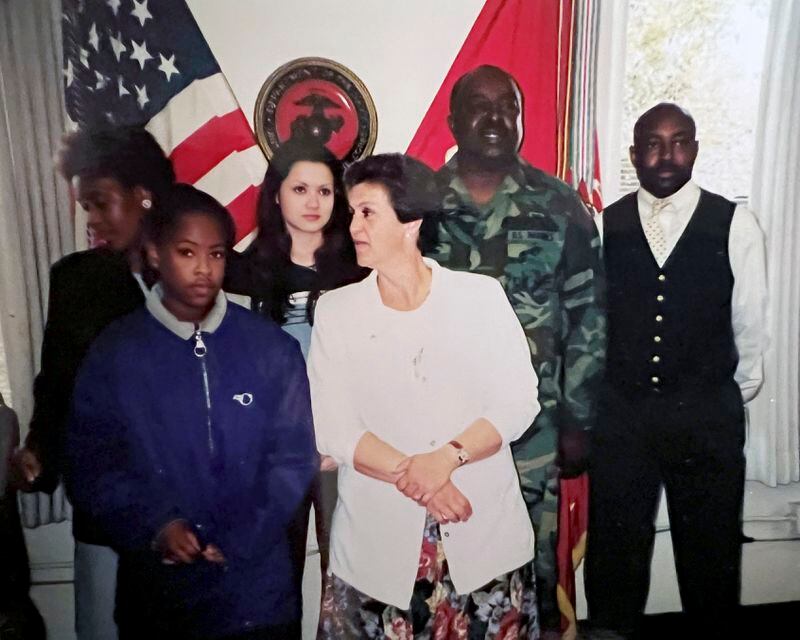 This family photo shows Carl Grant, second right, with his family at his retirement ceremony from the U.S. Marine Corps in California in 1999. At center in white jacket is his partner, Ronda Hernandez; background left is his sister, Kathy Jenkins, and his brother, William Jenkins, right. Grant had been a proud Marine who enlisted at 18 in 1969, following the example of a favored uncle. (Family photo via AP)