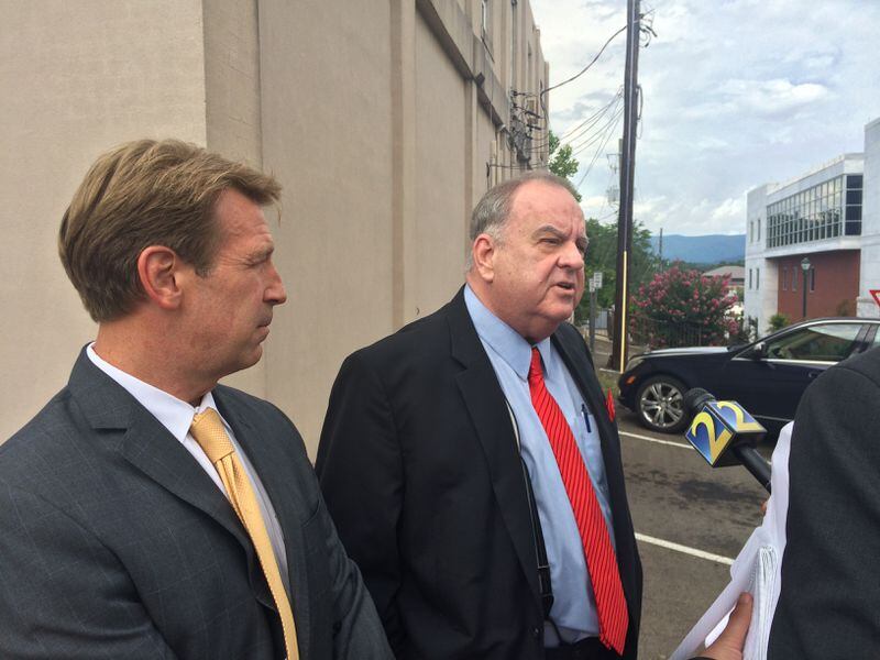 Attorney Russell Stookey, right, talks to media following the dismissal of charges against him Monday. Stookey said he has provided information to federal agents regarding spending by judges in Fannin County.