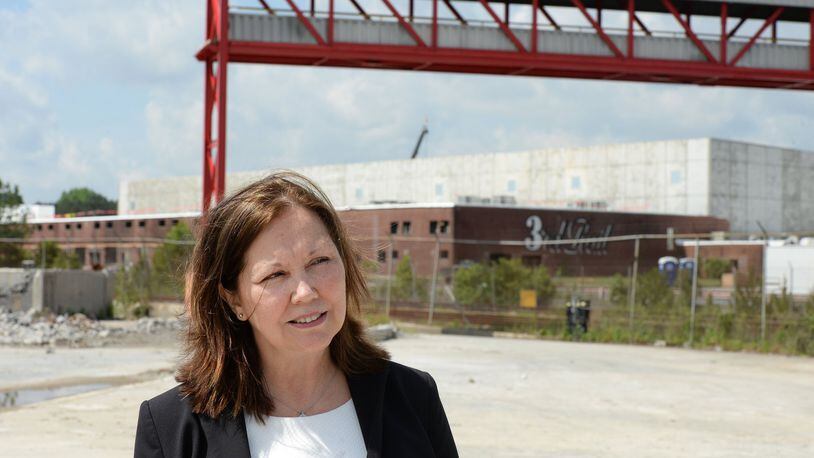 Doraville Mayor Donna Pittman walks through the construction site of Third Rail Studios in May 2016, one of the first developments at the former General Motors site. KENT D. JOHNSON /kdjohnson@ajc.com