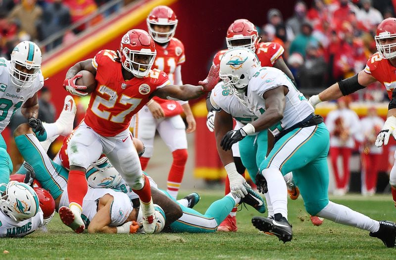 KANSAS CITY, MO - DECEMBER 24:  Running back Kareem Hunt #27 of the Kansas City Chiefs stiff arms outside linebacker Lawrence Timmons #94 of the Miami Dolphins during the second quarter of the game at Arrowhead Stadium on December 24, 2017 in Kansas City, Missouri. (Photo by Peter Aiken/Getty Images)
