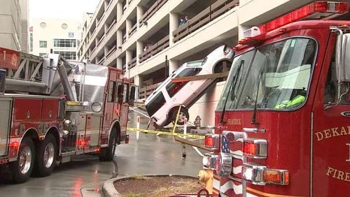 A driver was rescued Tuesday morning after crashing their SUV through an Emory University Hospital parking deck, authorities said.