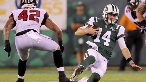 Jets quarterback Sam Darnold carries the ball as Falcons' Duke Riley defends during a preseason game Aug, 10, 2018,  at MetLife Stadium in East Rutherford, N.J.