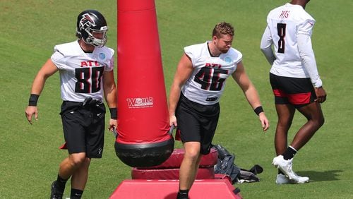 Falcons tight ends Ryan Becker (from left), Parker Hesse and Kyle Pitts take the field for some drills during team practice at minicamp Wednesday, June 10, 2021, in Flowery Branch. (Curtis Compton / Curtis.Compton@ajc.com)
