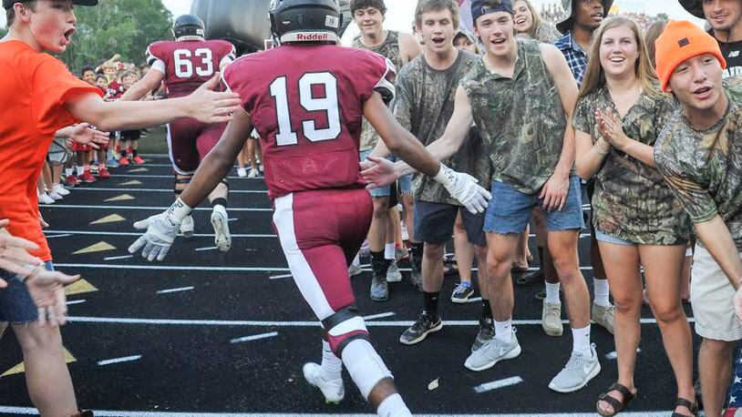 Alpharetta sophomore safety Vinny Dugassani enters the field to play West Forysth as fans cheer before a high school football game in Alpharetta, Friday, Sept., 4, 2015. (Photo/John Amis)