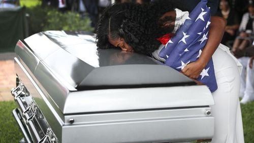 Myeshia Johnson kisses the casket of her husband, U.S. Army Sgt. La David Johnson, during his burial service at the Memorial Gardens East cemetery on Oct. 21, 2017, in Hollywood, Fla. Sgt. Johnson and three other American soldiers were killed in an ambush in Niger on Oct. 4. JOE RAEDLE / GETTY IMAGES