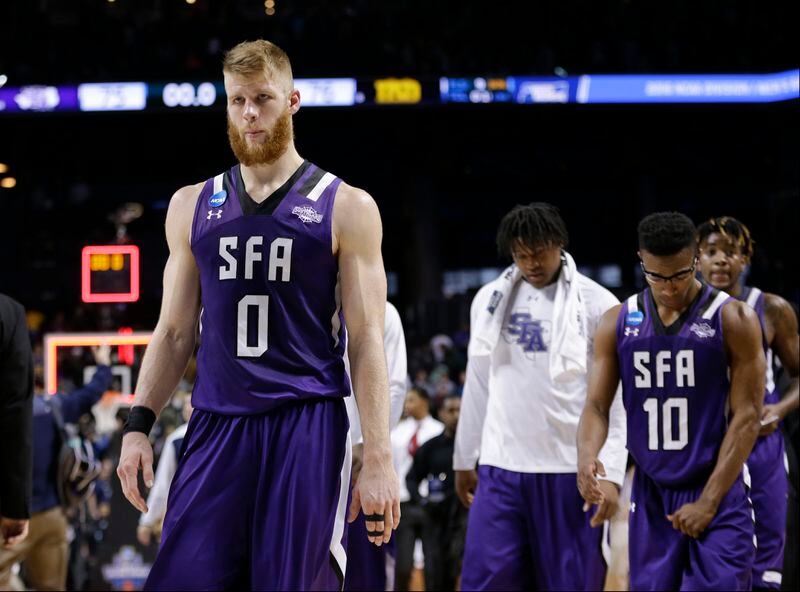 Stephen F. Austin's Thomas Walkup (0) and Trey Pinkney (10) leave the court after a second-round men's college basketball game against Notre Dame in the NCAA Tournament, Sunday, March 20, 2016, in New York. Notre Dame won 76-75. (AP Photo/Frank Franklin II)