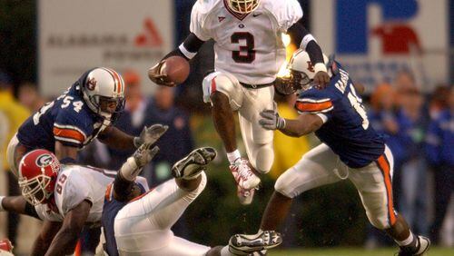 Georgia quarterback D.J Shockley leaps to elude a tackle in 2002. (Brant Sanderlin photo/Staff)