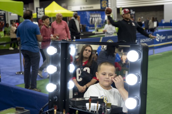 Camden Sams, 11, from Forsyth, has a football painted on his face during the SEC FanFare in Atlanta on Friday, Dec. 1, 2023.   (Ben Gray / Ben@BenGray.com)