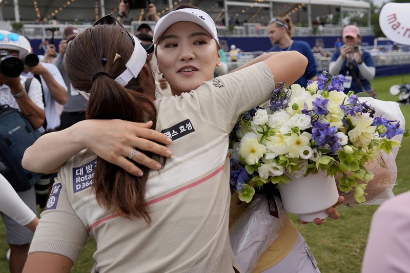 So Yeon Ryu, of South Korea, embraces fellow players after playing her final round during the second round of the Chevron Championship LPGA golf tournament Friday, April 19, 2024, at The Club at Carlton Woods, in The Woodlands, Texas. Ryu has announced she will retire after the tournament. (AP Photo/David J. Phillip)