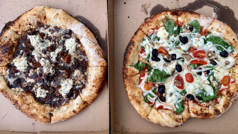 Here are two takeout pizzas from Phew’s Pies: the oxtail-ricotta and the veggie. Wendell Brock for The Atlanta Journal-Constitution