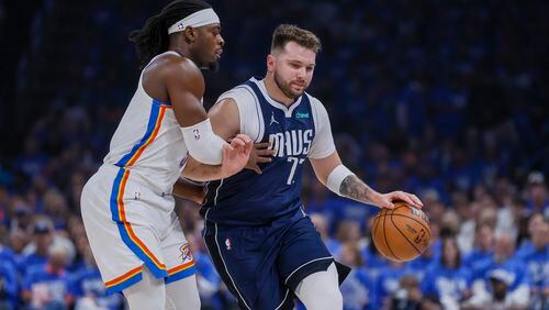 Dallas Mavericks guard Luka Doncic, right, drives against Oklahoma City Thunder guard Luguentz Dort during the first half of Game 1 of an NBA basketball second-round playoff series, Tuesday, May 7, 2024, in Oklahoma City. (AP Photo/Nate Billings)
