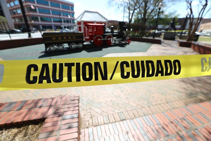 Police tape closes off the childrens play area from in the park on the Marietta Square on Thursday, March 26, 2020. (Curtis Compton ccompton@ajc.com)