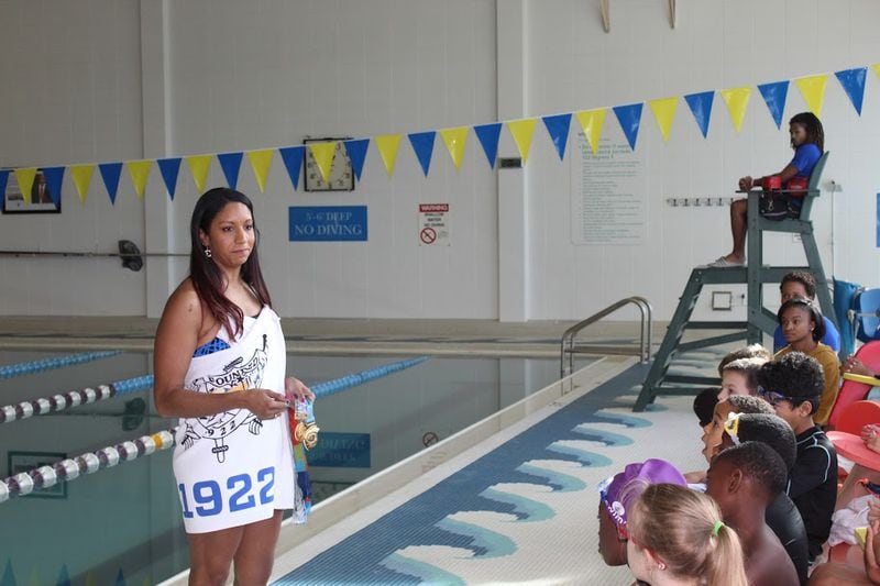 Sigma Gamma Rho member and Olympic silver medalist Maritza Correia McClendon coaches children as part of the sorority's Swim 1922 Program. McClendon was a 27-time All-American at the University of Georgia, winning 11 NCAA national titles.