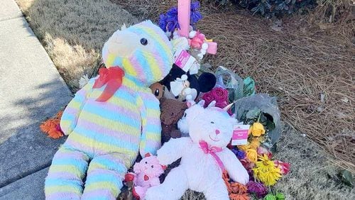 Stuffed animals and flowers are part of a memorial for a 7-year-old girl struck by a driver who didn't stop.