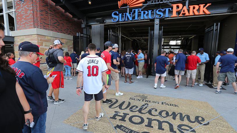 Fans enter the third base gate for the Braves home opener in their new stadium at SunTrust Park on Friday, April 14, 2017, in Atlanta. CURTIS COMPTON/CURTIS.COMPTON@AJC.COM