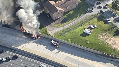 A hybrid caught fire and burned through the sound barrier in the I-75 Peach Pass Express Lanes in Marietta on Monday, September 18th, 2023. Credit: Doug Turnbull, WSB Skycopter