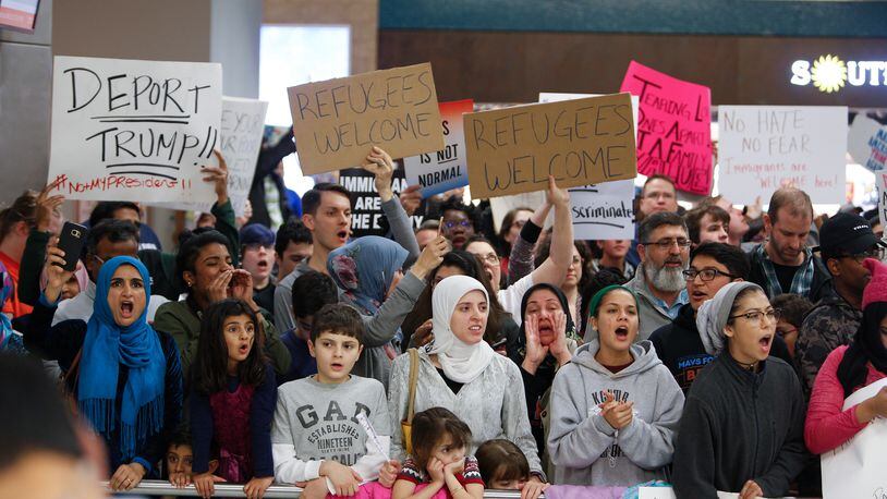 Protesters demonstrate againt Muslim immigration ban on Saturday, Jan. 28, 2017 at Dallas Fort-Worth Airport.
