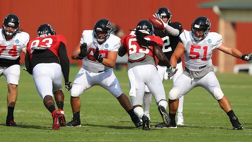 Falcons' offensive line blocks for Matt Ryan during team practice Monday, July 29, 2019, in Flowery Branch.