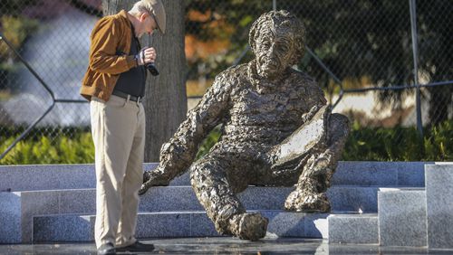 In this 2015 file photo, Jim Barksdale examines the star chart on the ground at the feet of the new Albert Einstein monument at Georgia Tech. John Spink, jspink@ajc.com