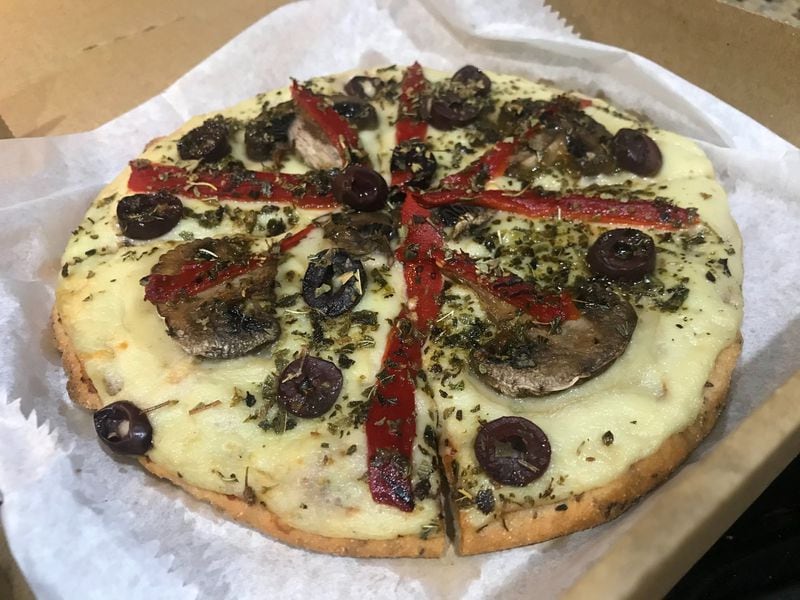 Huh! offers gluten-free, individual-sized pizzas. The crust is a flavorful blend of quinoa, amaranth and rice flours, as well as flax seed and sweet potatoes. LIGAYA FIGUERAS / LIGAYA.FIGUERAS@AJC.COM