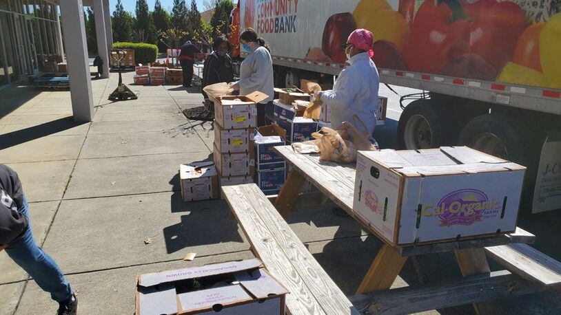 Atlanta Community Food Bank workers distribute food donations. The Food Bank works with over 700 nonprofits to serve more than 755,000 people each year.