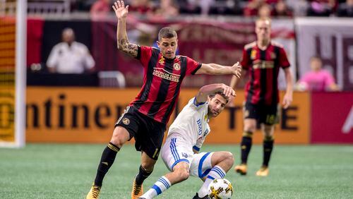 Atlanta United's Carlos Carmona tackles a Montreal player during Sunday's game at Mercedes-Benz Stadium. (Eric Rossitch / Atlanta United)