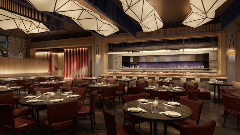 A dimly lit main dining room at Nobu Atlanta offers a view of the sushi counter and open kitchen. NOBU HOSPITALITY