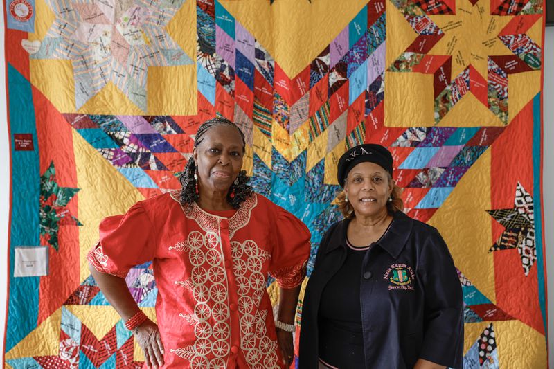 Alcelia Scott-Ford (left) embroidered hundreds of names onto  Stockbridge's centennial quilt, whose creation was overseen by Aisha Lumumba (right). (Natrice Miller/ Natrice.miller@ajc.com)