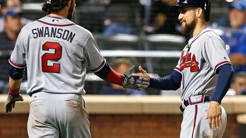 Atlanta Braves' Dansby Swanson (2) and Braves' Ender Inciarte celebrate after scoring on Freddie Freeman's fourth-inning two-run double in a baseball game against the New York Mets, Monday, Sept. 19, 2016, in New York. (AP Photo/Kathy Willens)