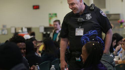 DeKalb County School District school resource officer Johnny Burnette wears a  body camera that captures 360-degree views while he speaks with students at Clarkston High School. The district launched a body-worn camera pilot program in March. ELIJAH NOUVELAGE/SPECIAL
