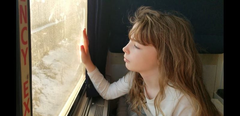Bella Thornton, 9, looks out the window of Crescent Train 20 on Tuesday, Jan. 4, 2022. The train, which departed Atlanta early Monday morning has been delayed by a winter storm that dropped trees on the train tracks. (Photo courtesy of Sean R. Thornton)