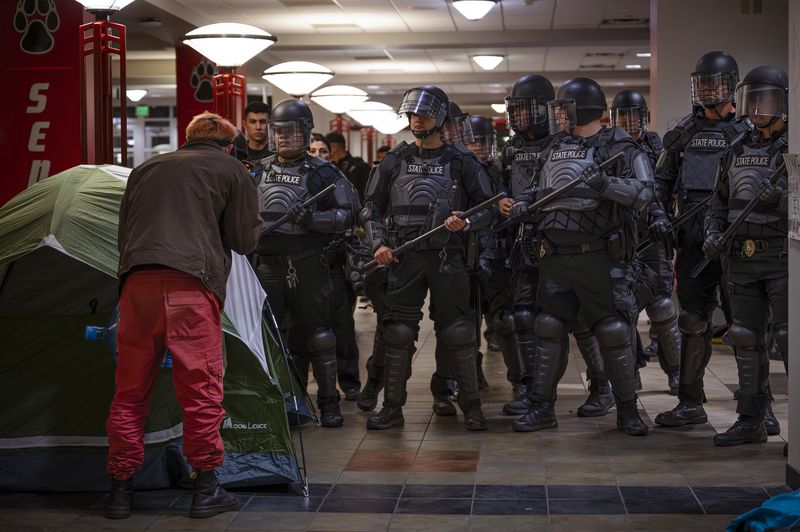 New Mexico State Police and UNM police prepare to make arrests of pro-Palestinian protesters occupying the Student Union building at the University of New Mexico in Albuquerque, N.M., on early Tuesday morning, April 30, 2024. (Chancey Bush/The Albuquerque Journal via AP)