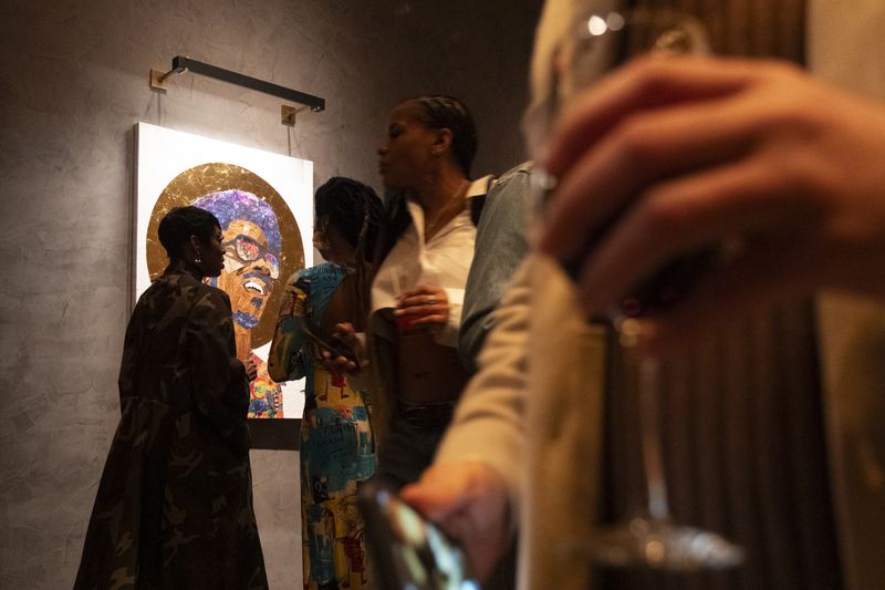 People mingle during Art Melanated’s Stevie Wonder exhibit opening at Thompson Atlanta in Buckhead on Friday, Feb. 2, 2024.   (Ben Gray / Ben@BenGray.com)