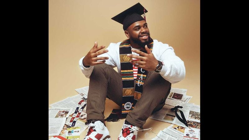 Clark Atlanta University graduating senior Ashton Edmunds is surrounded by some of the articles he's written. Edmunds, an aspiring sports journalist, plans to pursue his master's degree at Northwestern University. (Courtesy of Sean Bartley)