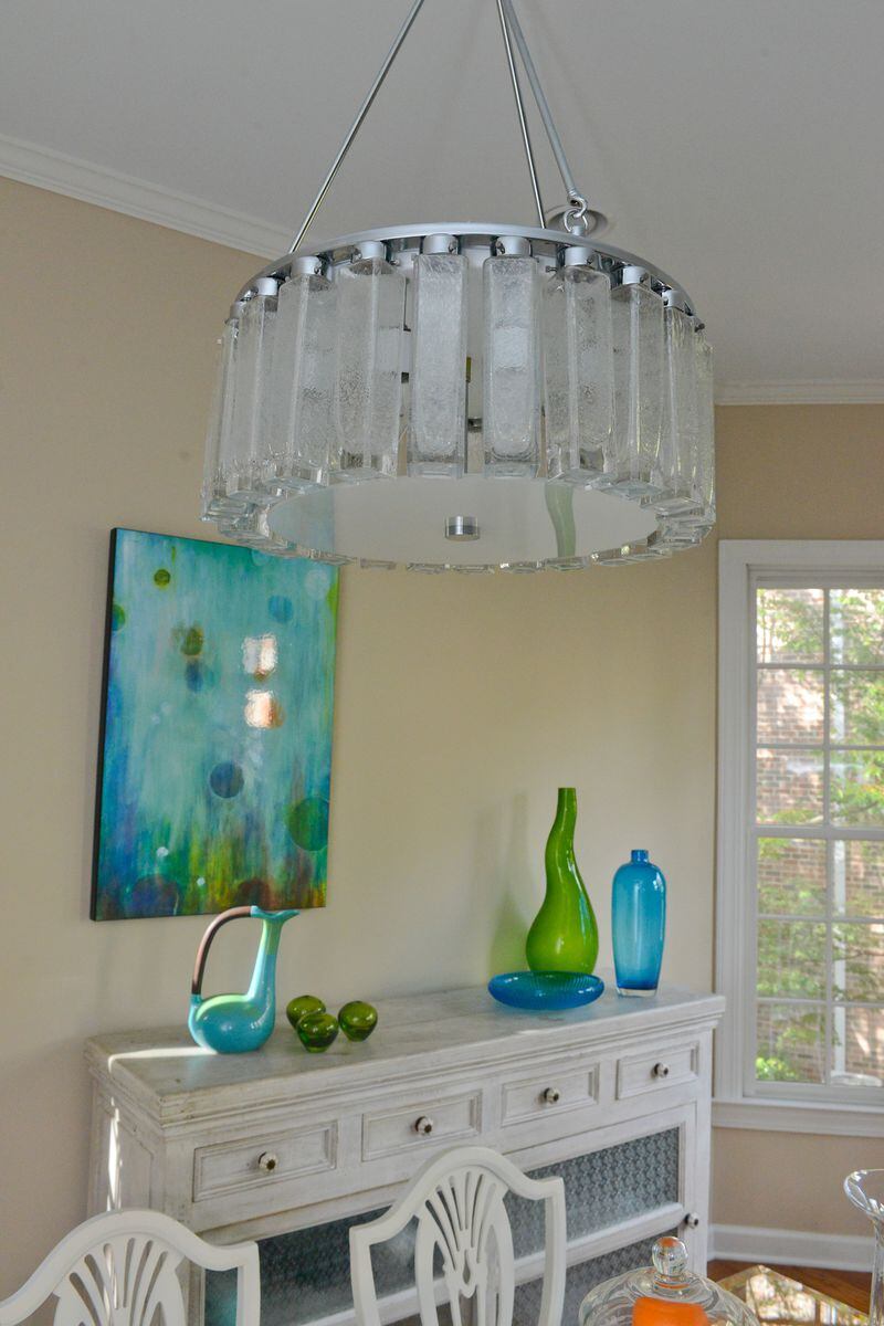 A Murano glass tube chandelier from Antique Factory, in Chamblee, hangs above the glass dining table in the dining room of Pedro Ayestaran Diaz and Jeffrey Chandler. Text by Lori Johnston and Keith Still/Fast Copy News Service. (Christopher Oquendo Photography/www.ophotography.com)