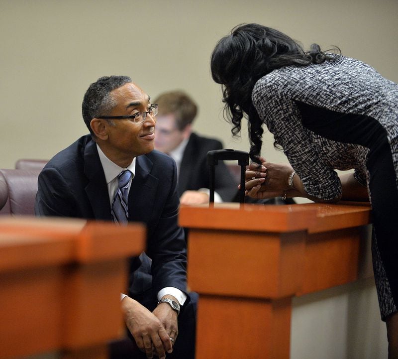 Burrell Ellis talks with his wife, Philippa, inside DeKalb County Superior Court Judge Courtney Johnson’s courtroom in June 2015. 