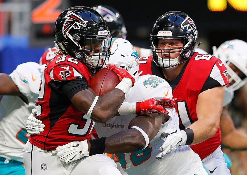 ATLANTA, GA - AUGUST 30:  Justin Crawford #32 of the Atlanta Falcons rushes against Kendall Langford #98 of the Miami Dolphins at Mercedes-Benz Stadium on August 30, 2018 in Atlanta, Georgia.  (Photo by Kevin C. Cox/Getty Images)