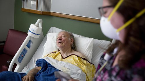 Henry Beverly, 73, battles the flu while tended to by nurse Kathleen Burks at Upson Regional Medical Center in Thomaston, Georgia, on Feb. 9, 2018. (AP Photo/David Goldman)