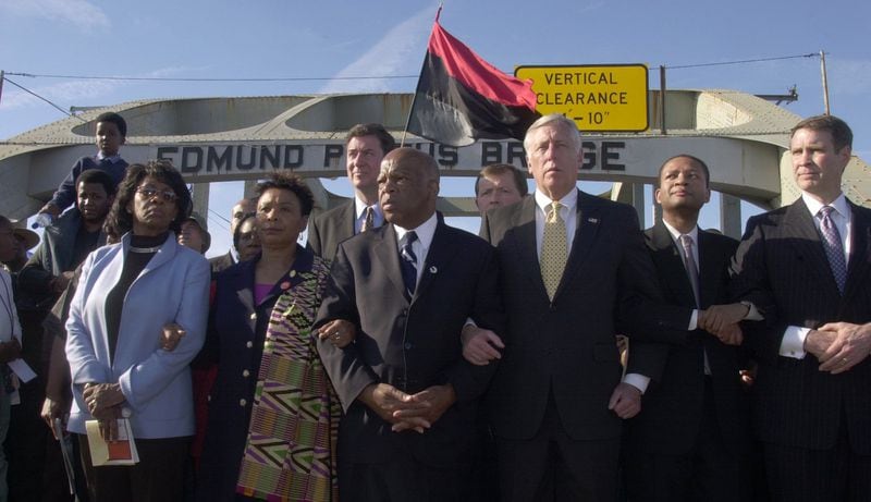 U.S. House Majority Leader Steny Hoyer, shown with his arm locked with that of U.S. Rep. John Lewis on the 40th anniversary of the Selma-to-Montgomery voting rights march, got to know Lewis well during the 34 years Lewis served in Congress. “When he called you brother, you had the sense that he meant it,” Hoyer said. “It wasn’t just rhetoric. It was a relationship he believed he had with others.” (AP Photo/Kevin Glackmeyer)